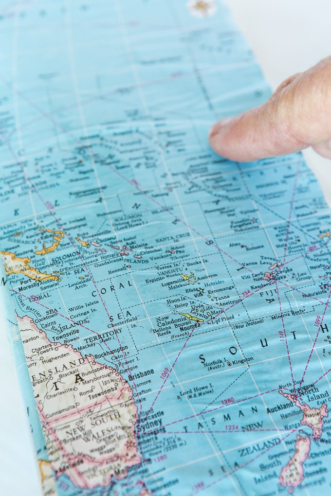 DIY map wallpaper step by step tutorial that shows how to remove wrinkles that may appear when applying maps and or paper to walls