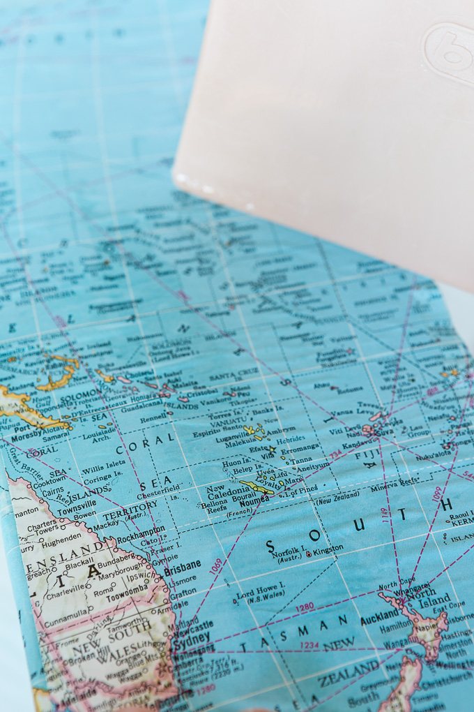 DIY map wallpaper step by step tutorial that shows how to remove wrinkles that may appear when applying maps and or paper to walls