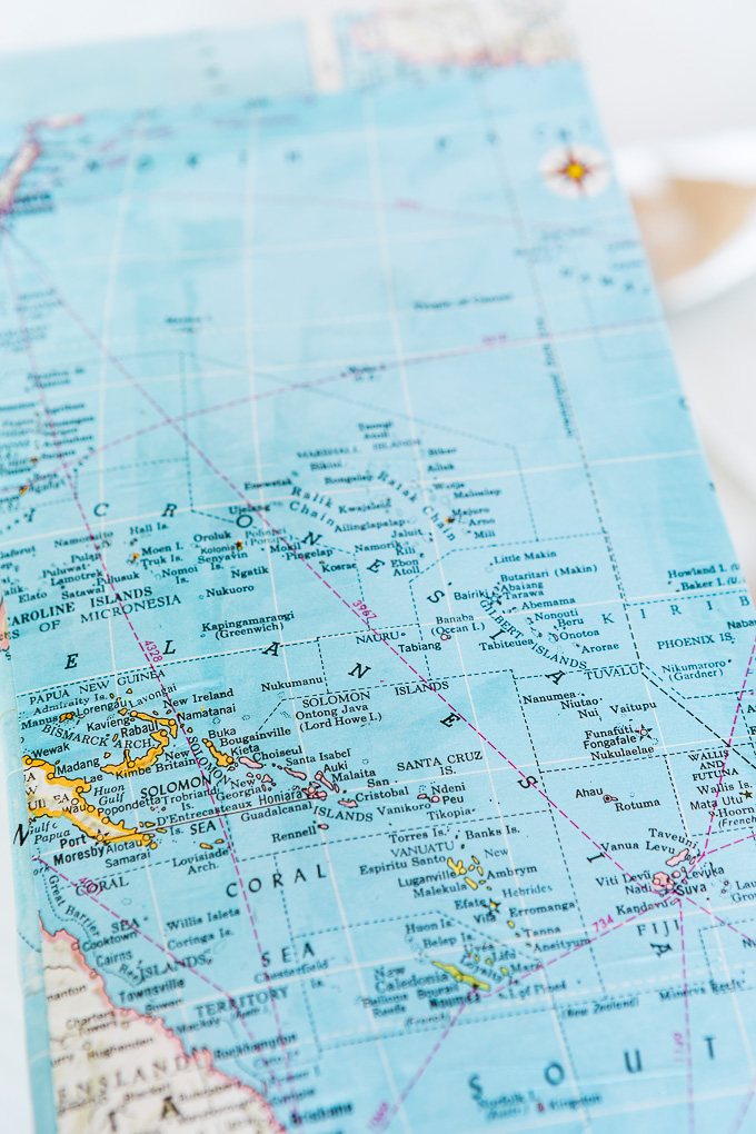 DIY map wallpaper step by step tutorial that shows how to remove wrinkles that may appear when applying maps and or paper to walls
