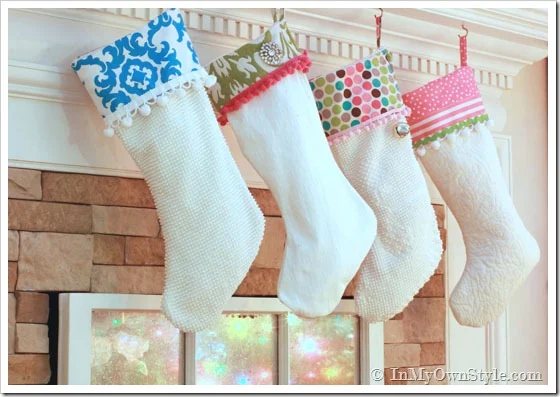 Colorful holiday stockings hanging along a mantel