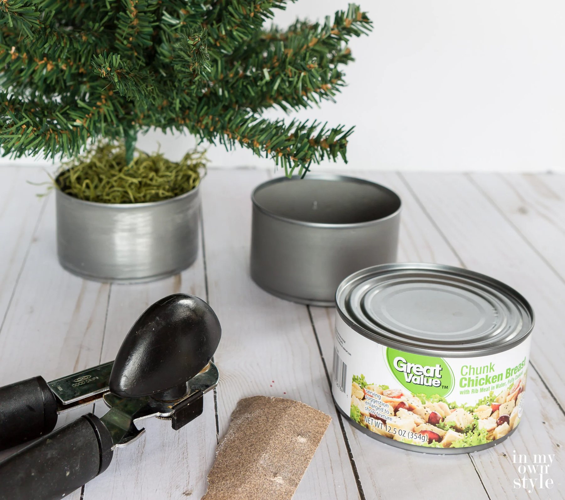 Metal tuna and chicken cans can be used as mini Christmas tree bases.