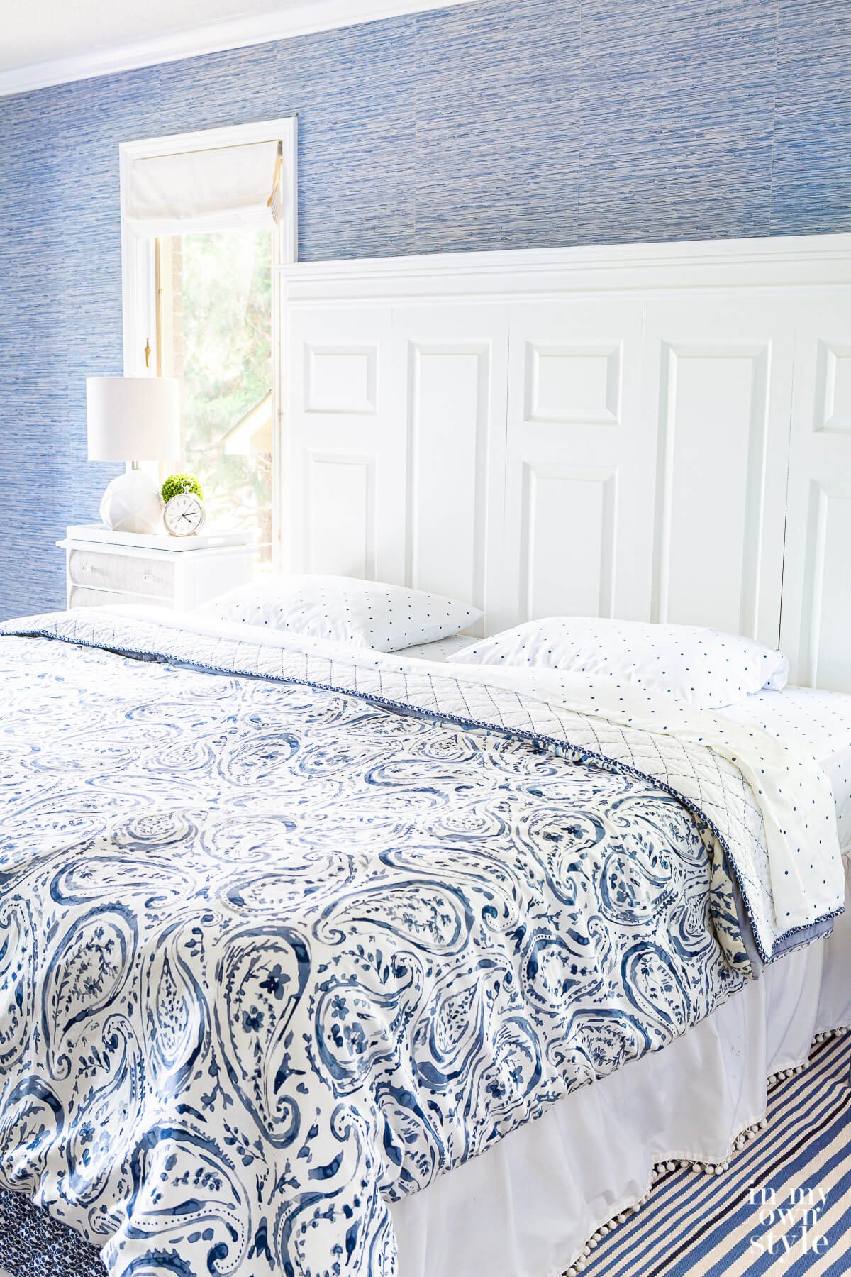 navy blue and white mix and match bedding on a king size bed