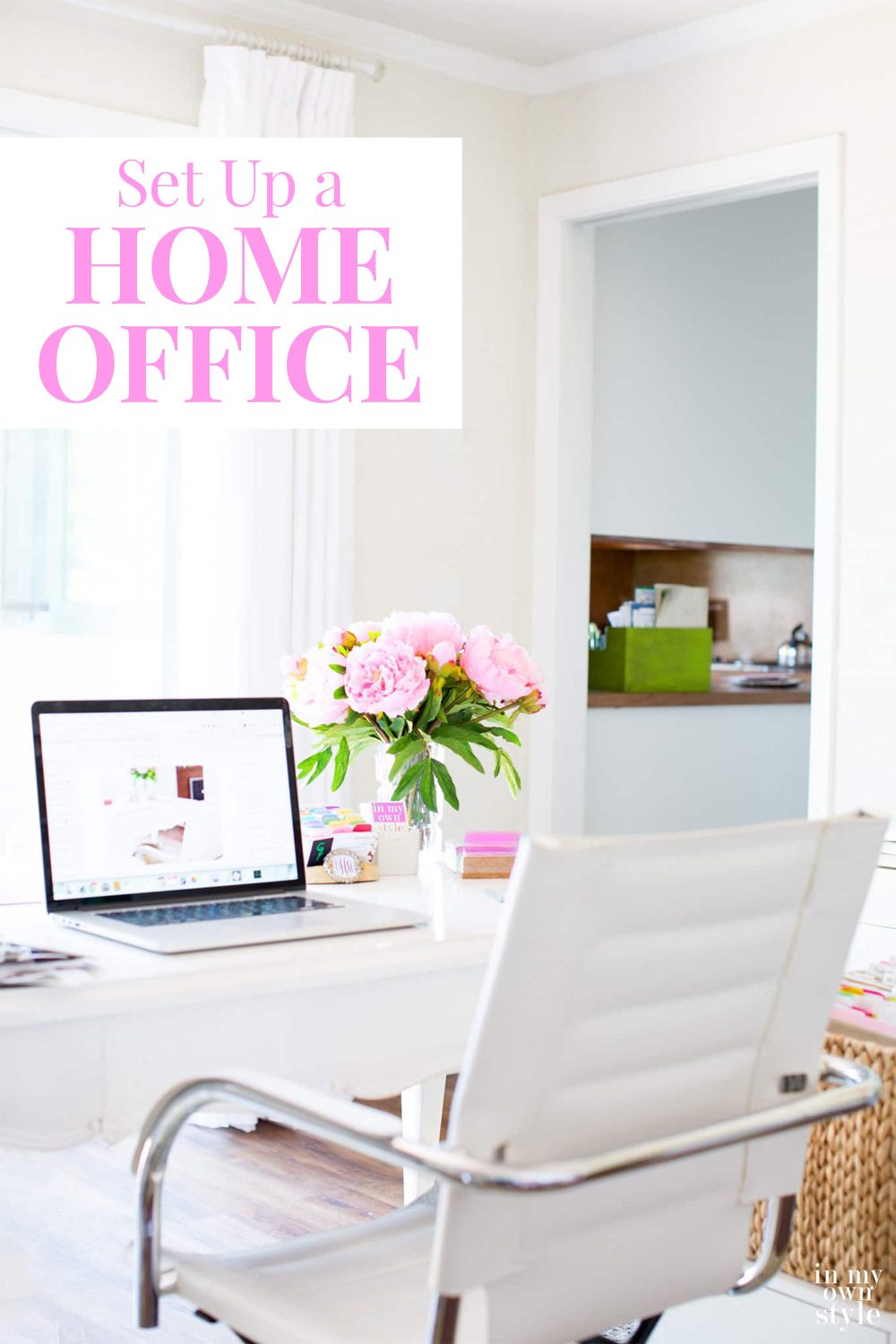 A home office with a white and pink color palette.