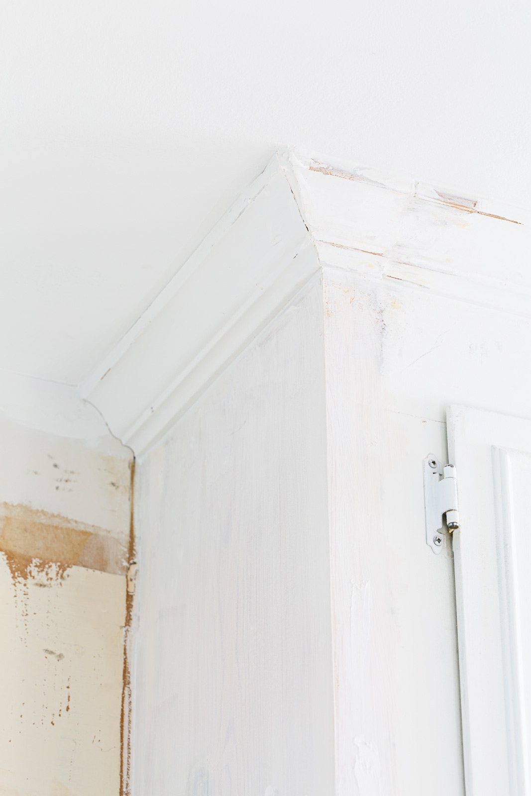 Adding molding back to upper cabinet in kitchen.