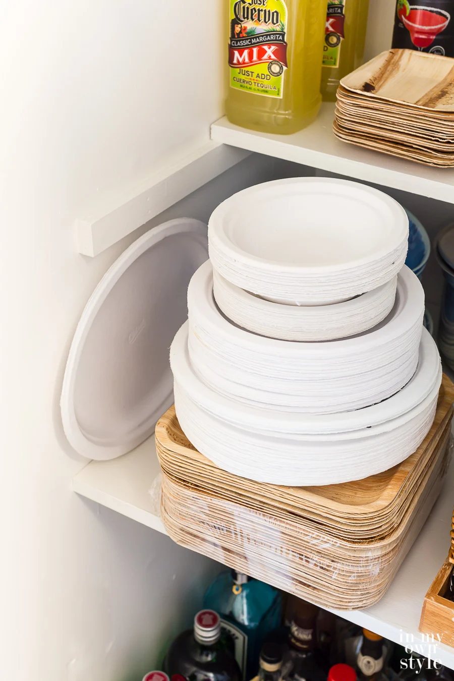 White paper plates stacked in entertaining supply closet.