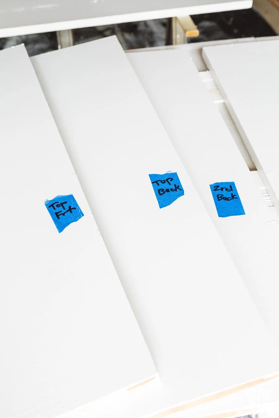 Blue painters tape made into labels to number shelves if removing them from closet before painting.