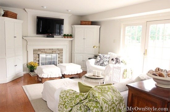 White decorated living room with hardwood floors.