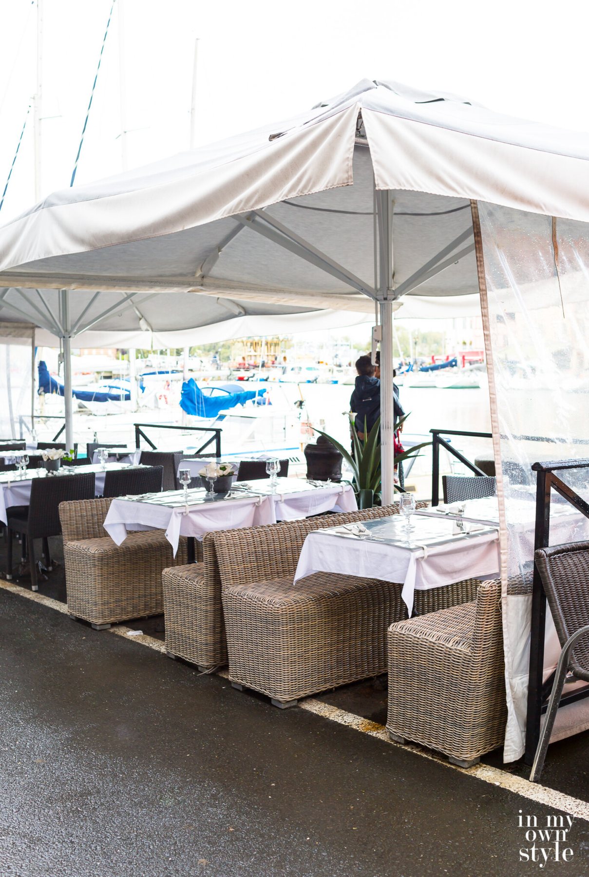 Outdoor cafes in the rain in Honfleur on the coast of Normandy