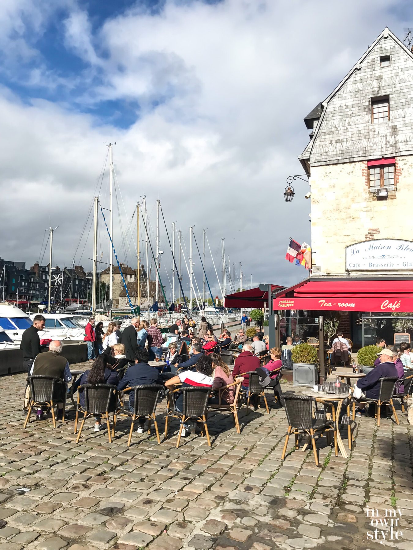 Outdoor cafe along water in Honfleur France