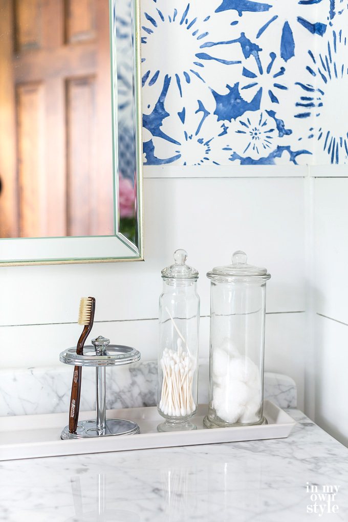How to use small trays to organize items on a bathroom counter.