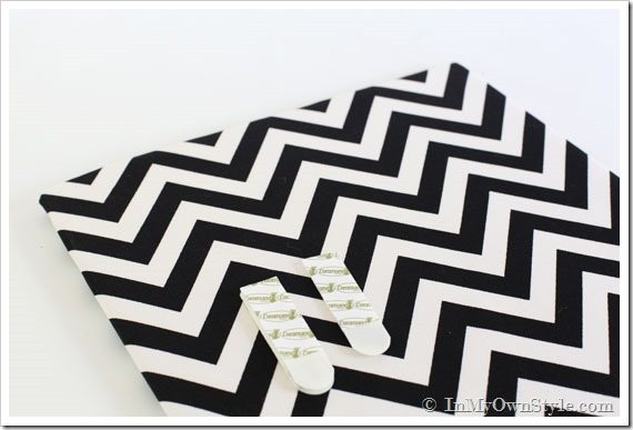 Fabric wrapped foam showing where to put Command Brand strips to hang it on cabinet door.