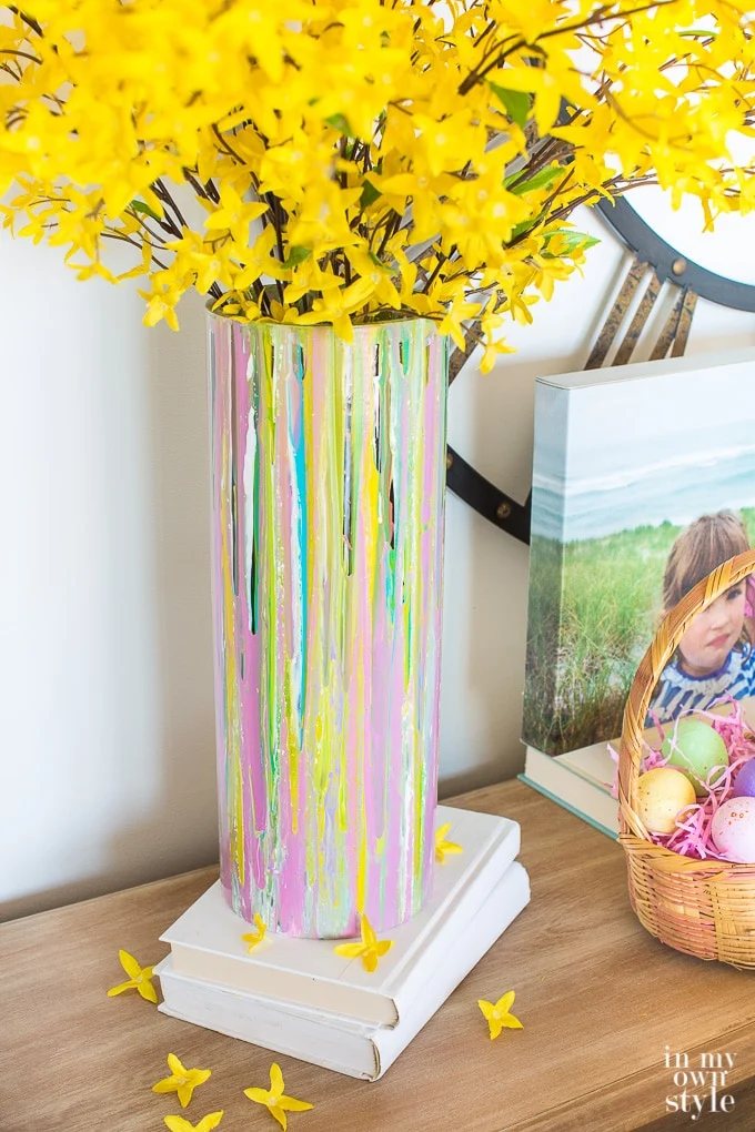 Spring decor. Painted glass vase on a console table