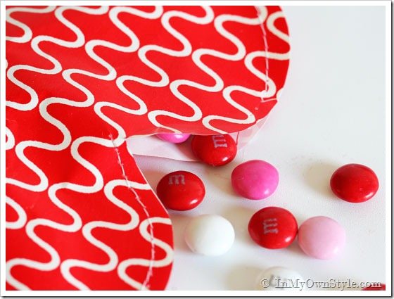 Red gift wrap paper made into a heart candy pouch.