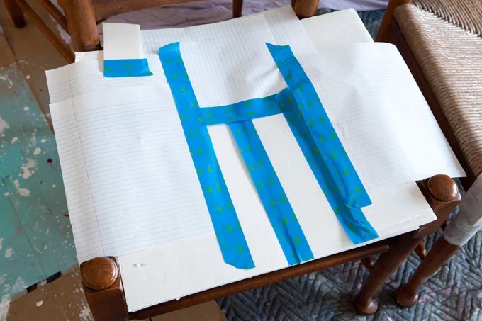 Furniture-painting-tips-on-how-to-mask-areas-you-don't-want-painted on dining chairs.
