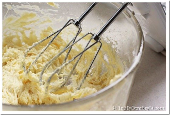Christmas-cookies being beaten in a mixing bowl.