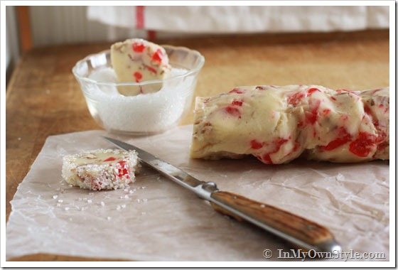 Dough logs being cut and dipped into sanding sugar.