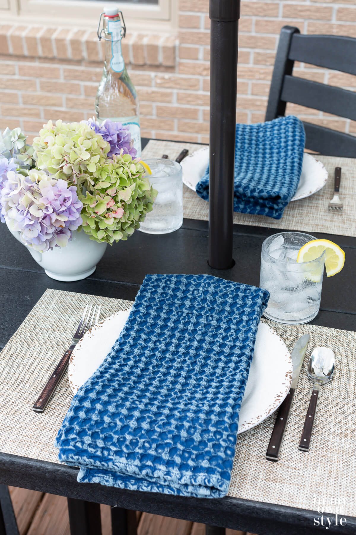 Black POLYWOOD bar height table set for dining alfresco.
