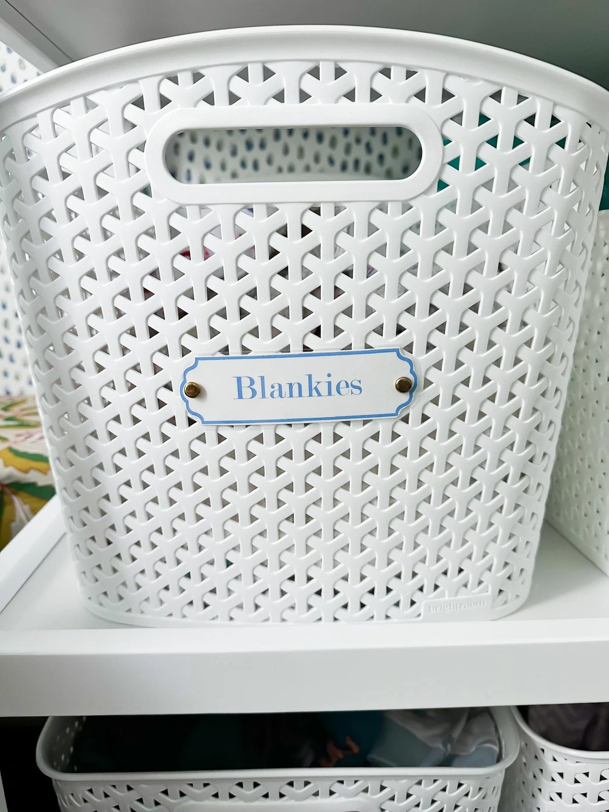 close up of a baby nursery label on a white plastic basket