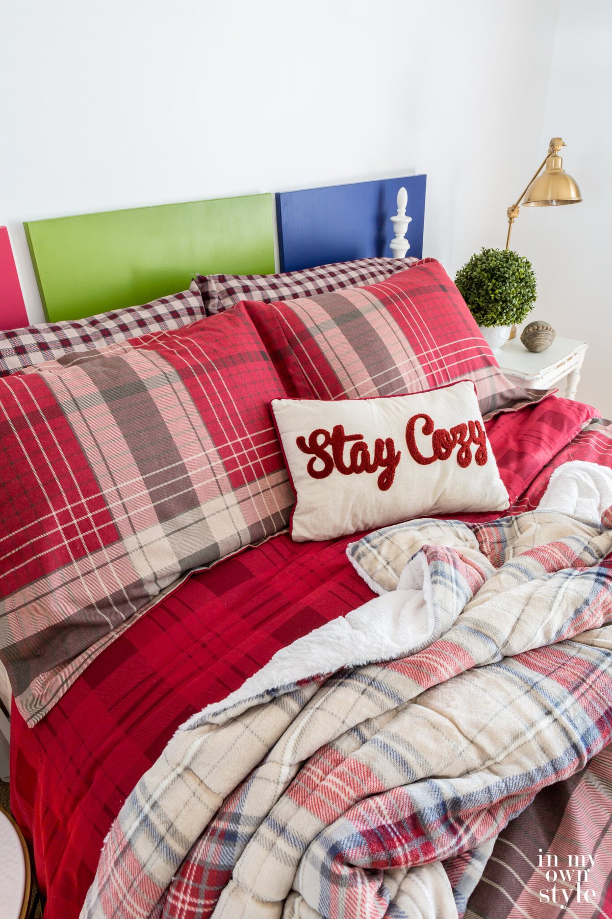 .CuddlDuds Red Plaid bedding from Kohls on bed in a guest room.