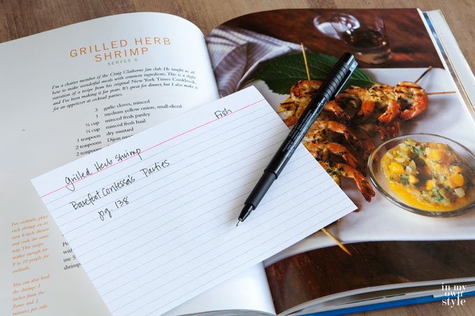 Cross referencing recipe card and cookbook.