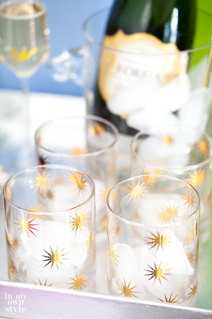 New Years Eve Barware on tray with a bottle of champagne in the background.