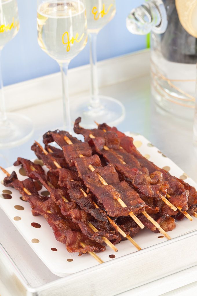 Spiced Bacon Skewers piled up on festive serving plate.