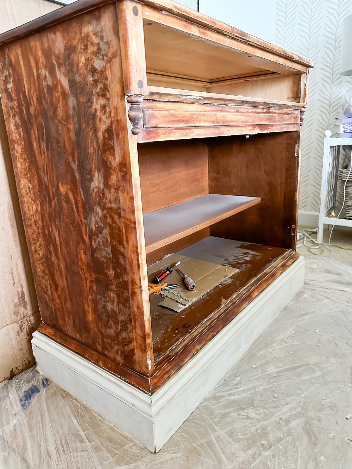 view of wood cabinet after paint stripping.