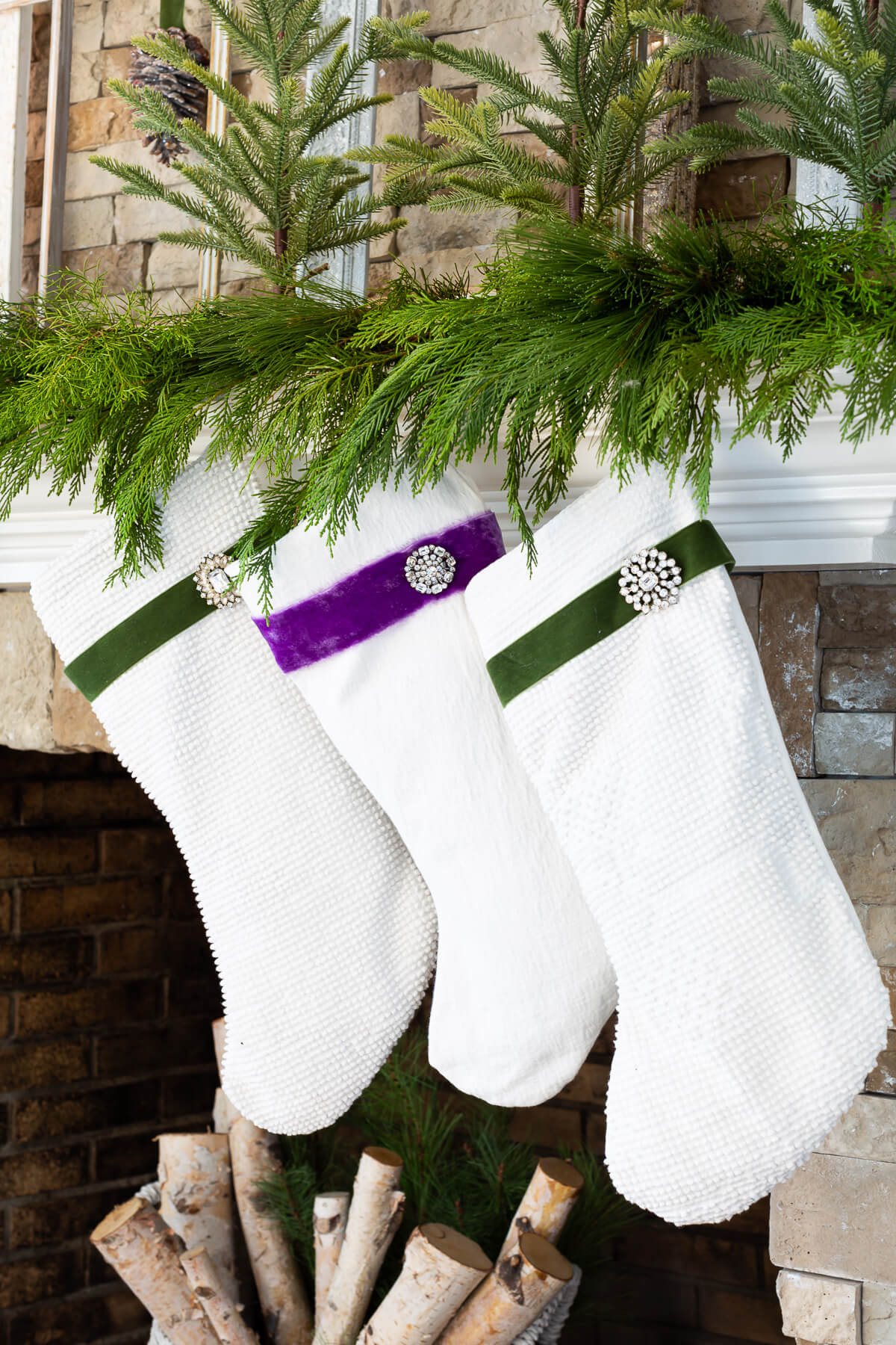 3 white Christmas stockings hanging on mantel.