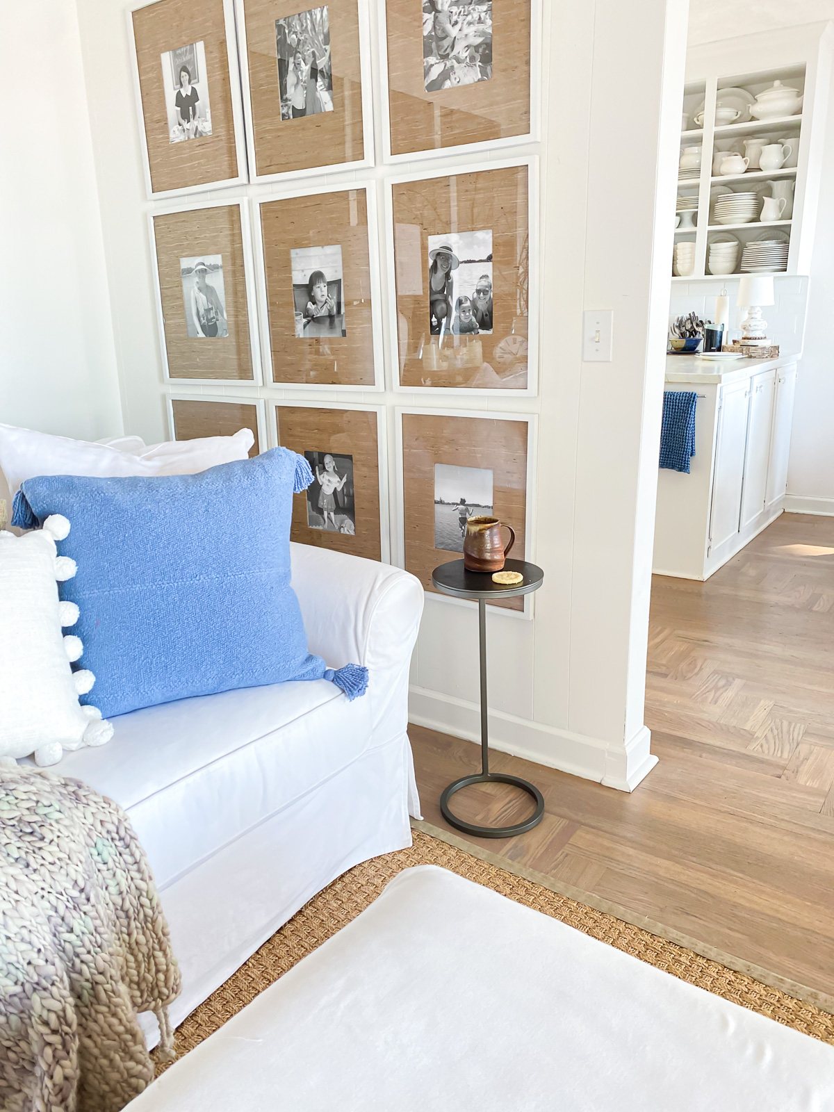 A corner in a living room with a sofa and small accent table to hold a drink.