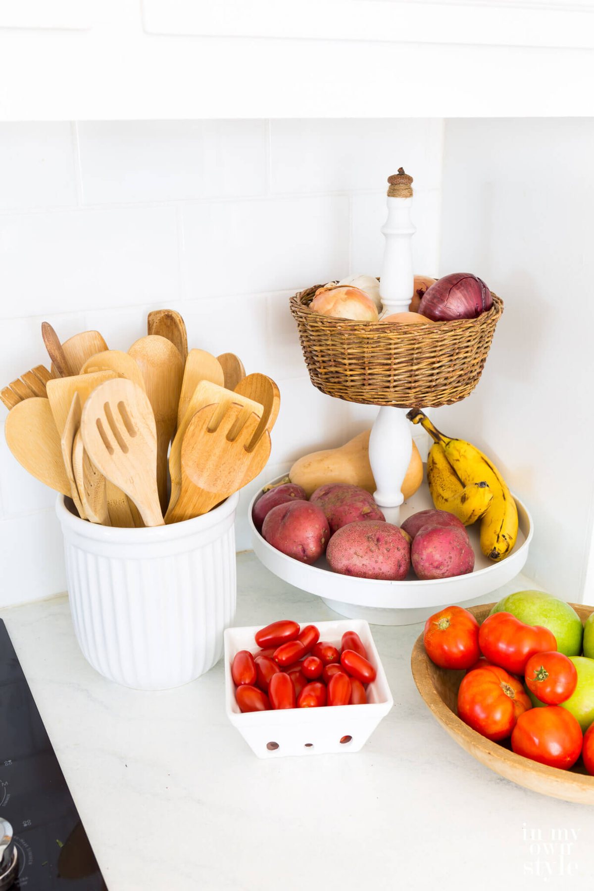 Tiered kitchen basket to make to store fruit and produce on a counter.