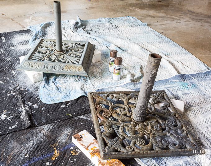 Two outdoor patio umbrella stands waiting for a spray paint makeover