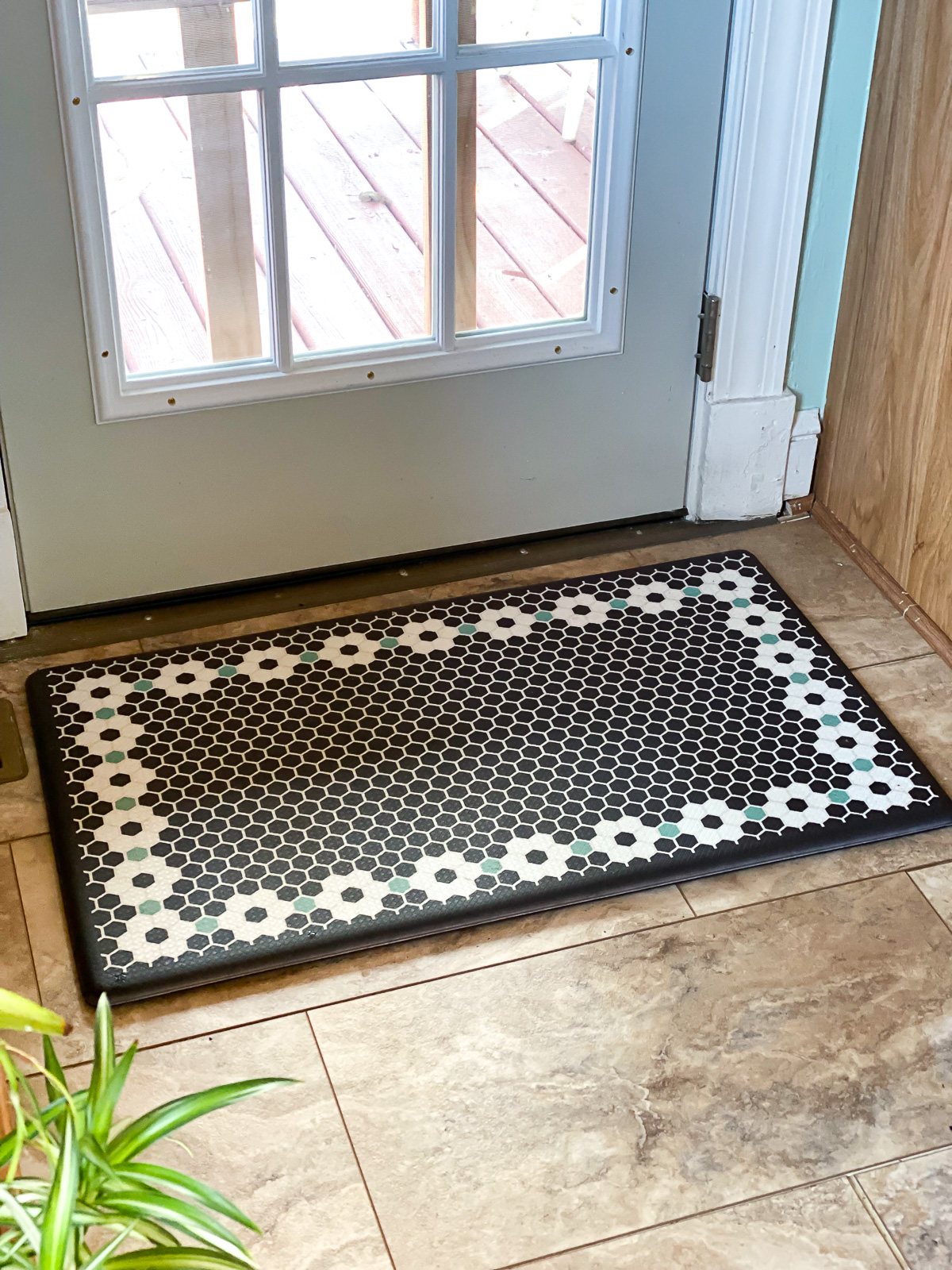 gel mat with tile pattern on floor in front of French door