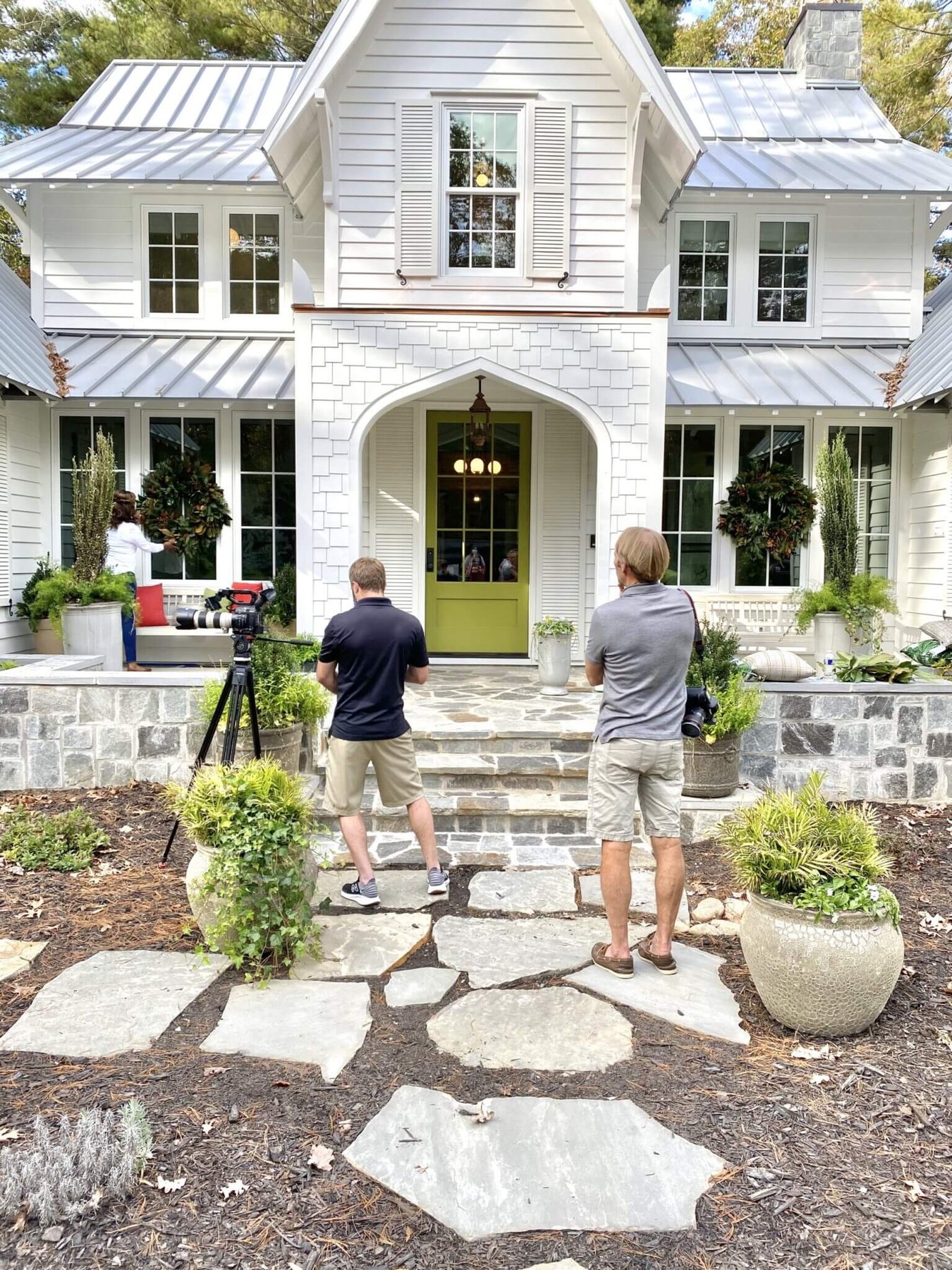 Photographer and stylist outside the front of the Southern Living Idea House