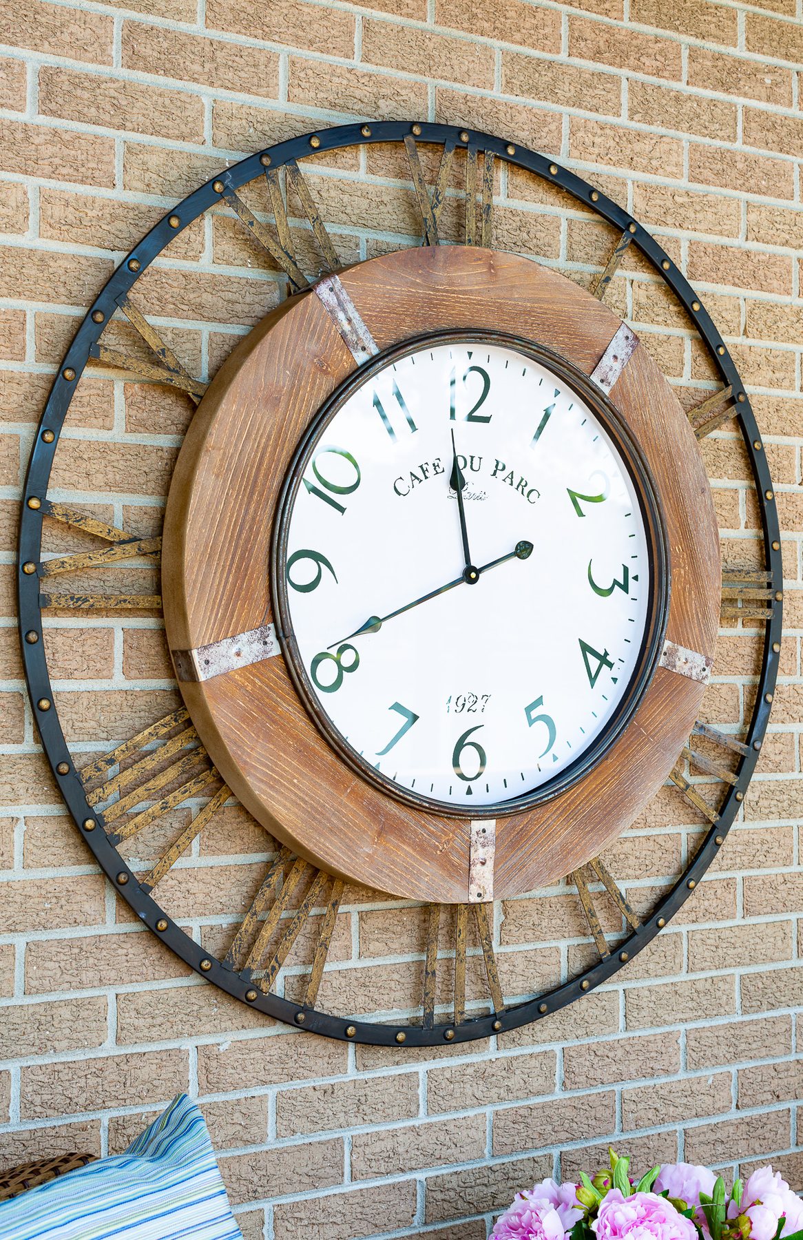 large outdoor wall clock on exterior brick wall