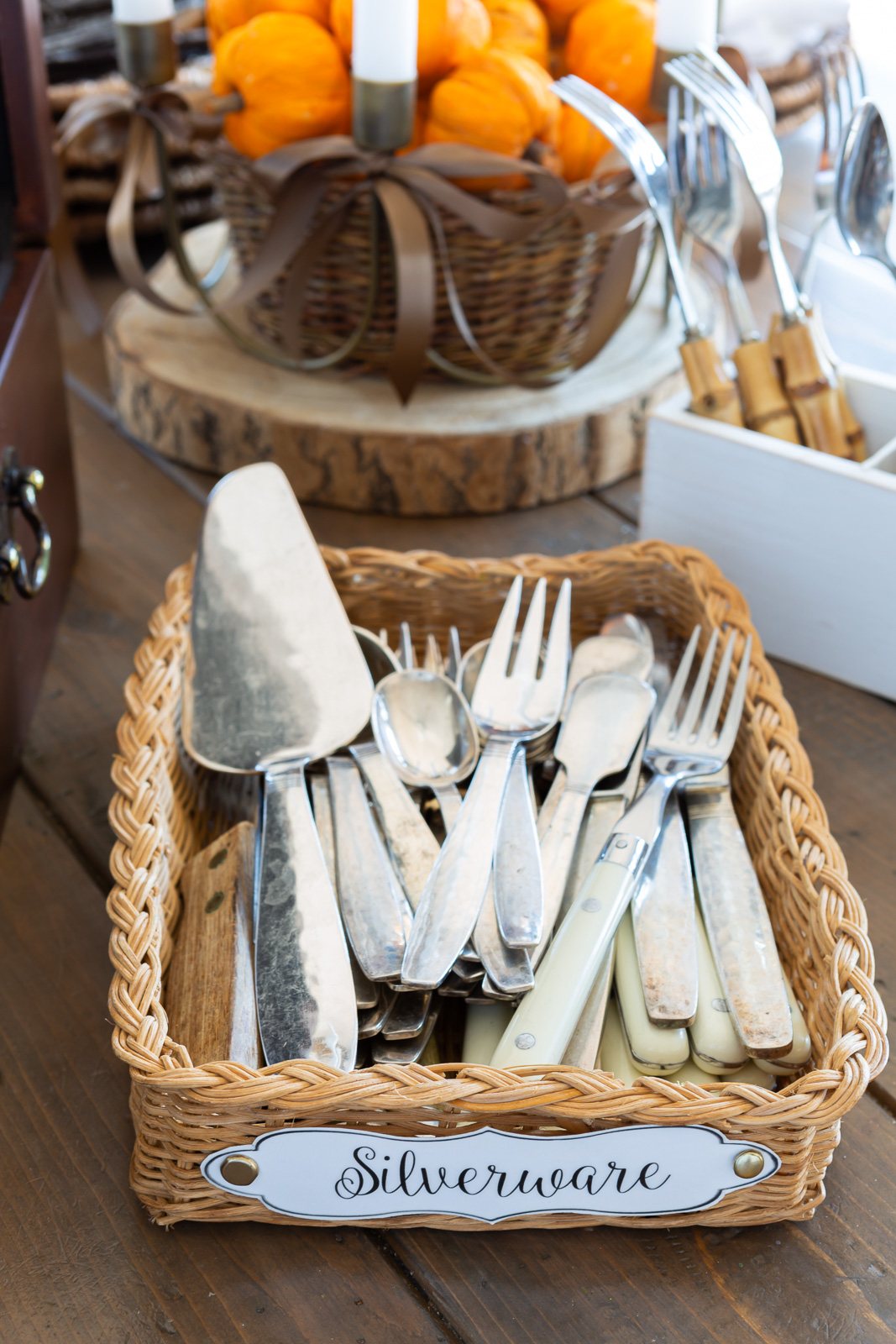 a basket filled with silverware on a table