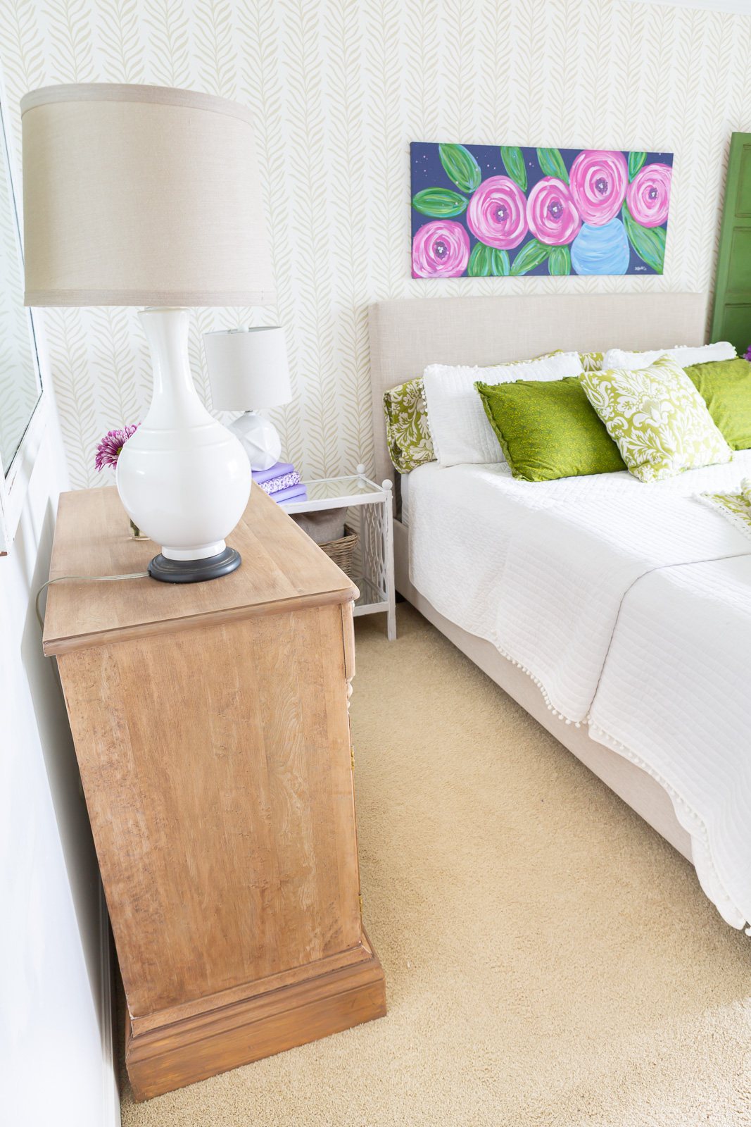 Guest room with stripped wood cabinet against wall.