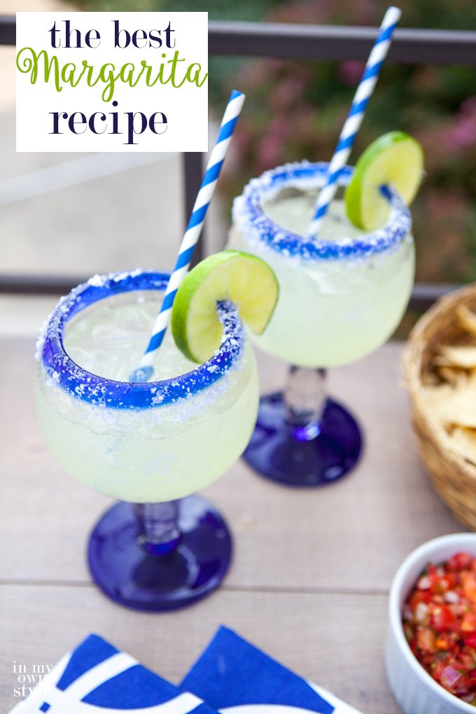Two filled margarita glasses with salted rims, limes and blue and white striped straws. This is the Margarita recipe you have been searching for. It is the best! Pitcher size recipe.