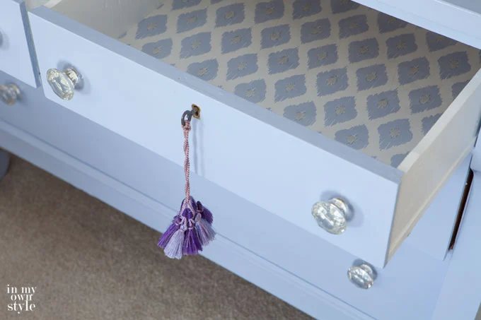 Use decorative gift wrap or wall paper to line the drawers of a dresser