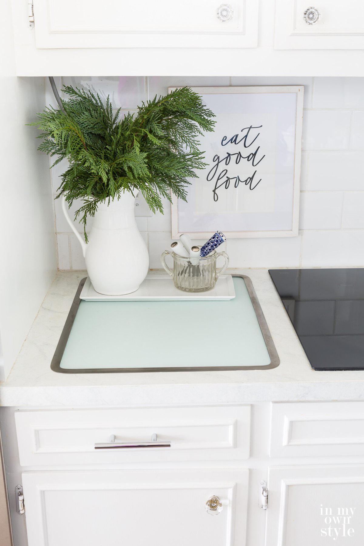 Vance Industries Surface Saver in counter glass cutting board. Framed art on wall says eat good food.