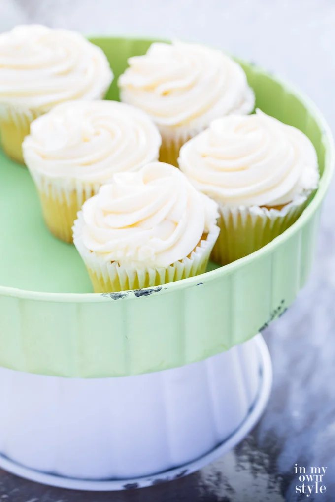 Vanilla cupcakes on pedestal server from the Trisha Yearwood Home Collection at Tractor Supply stores.
