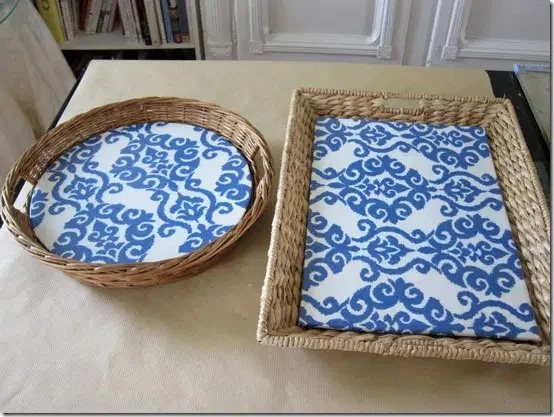 two wicker basket trays with blue and white decorative fabric inserts