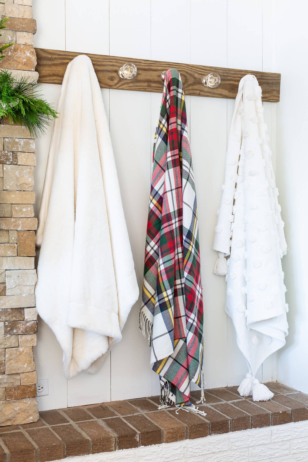 how to decorate with throw blankets. Use a wall mounted blanket holder in a living room.