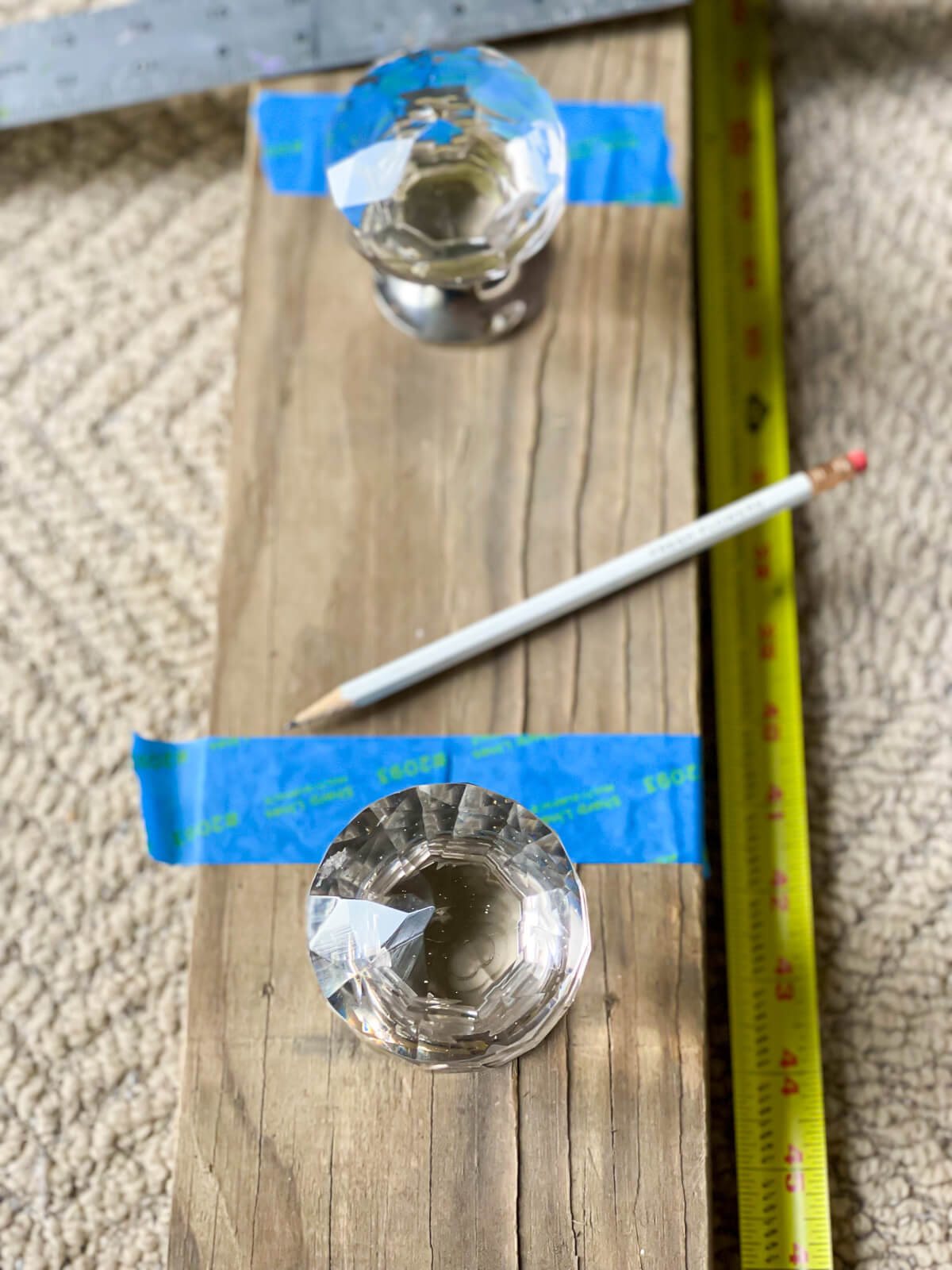 How to center doorknobs for blanket rack on wood board.