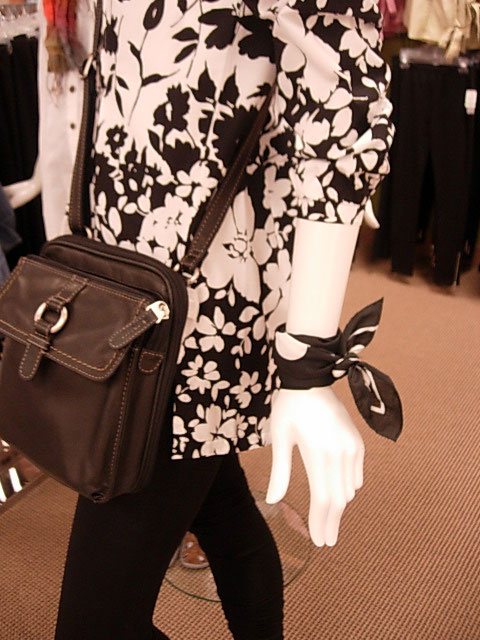 black and white cotton scarf tied around a wrist.
