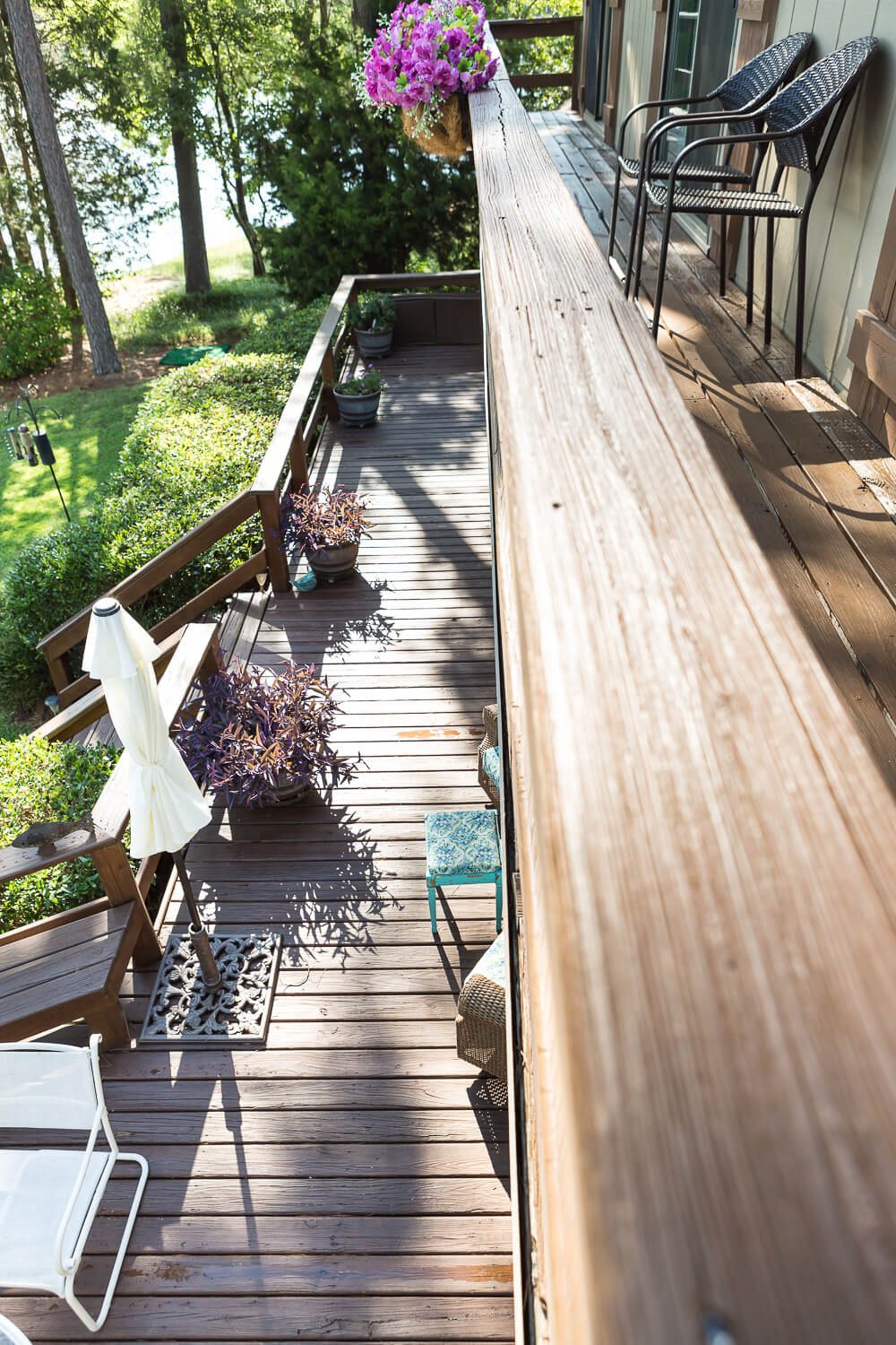 Standing on freshly stained deck looking down into yard and lake.