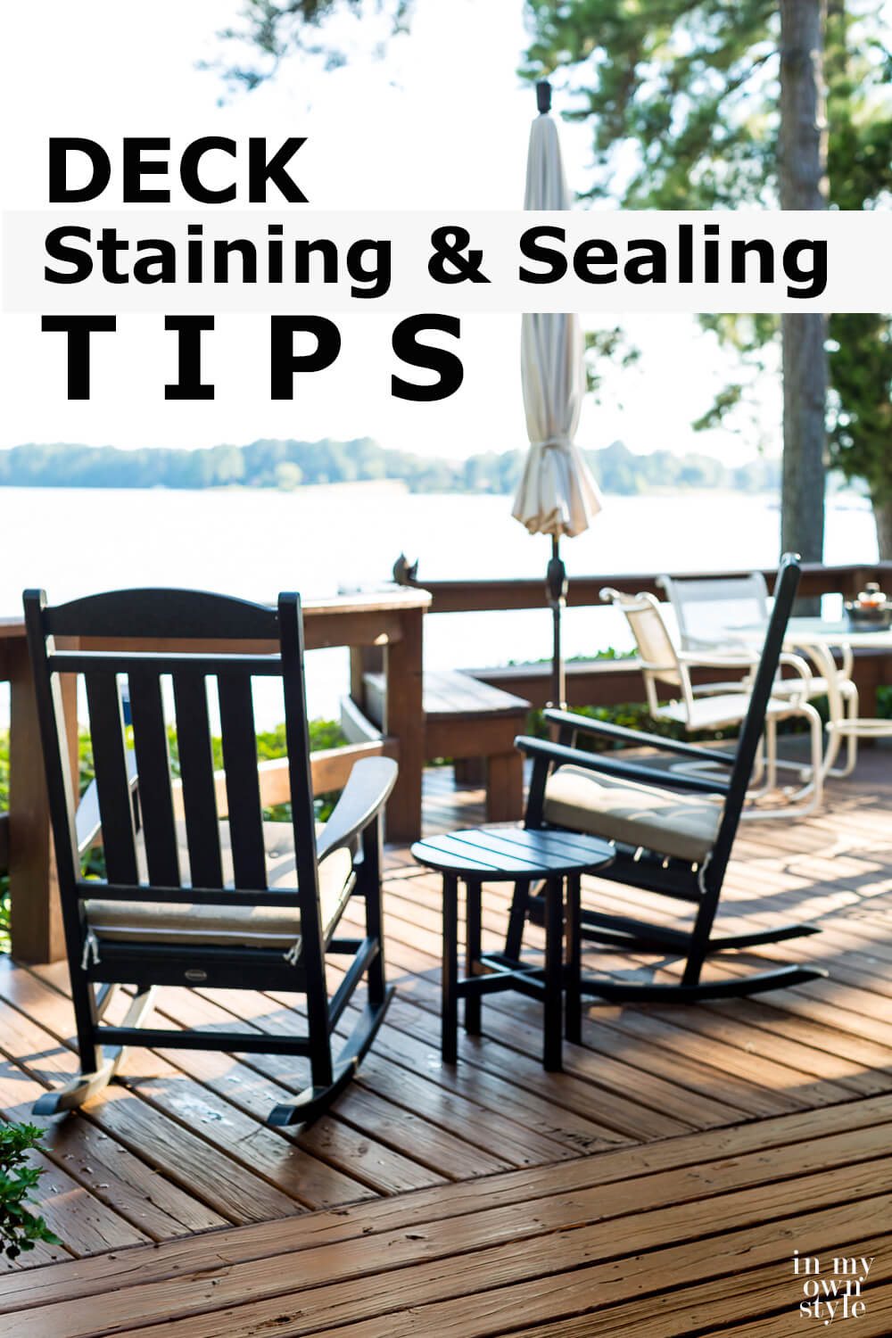 Two black outdoor rockers on lakeside deck. Text overlay says Deck Staining and Sealing Tips