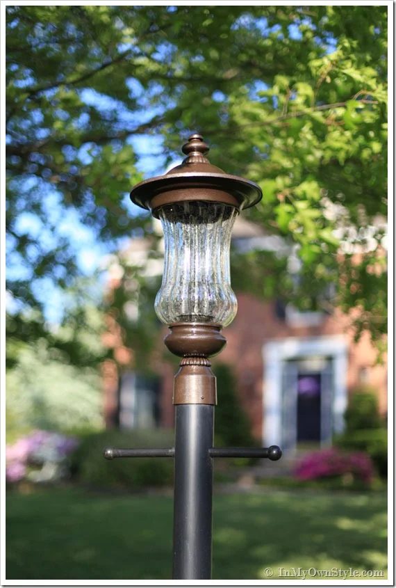 Outdoor carriage light in yard after getting a paint makeover.