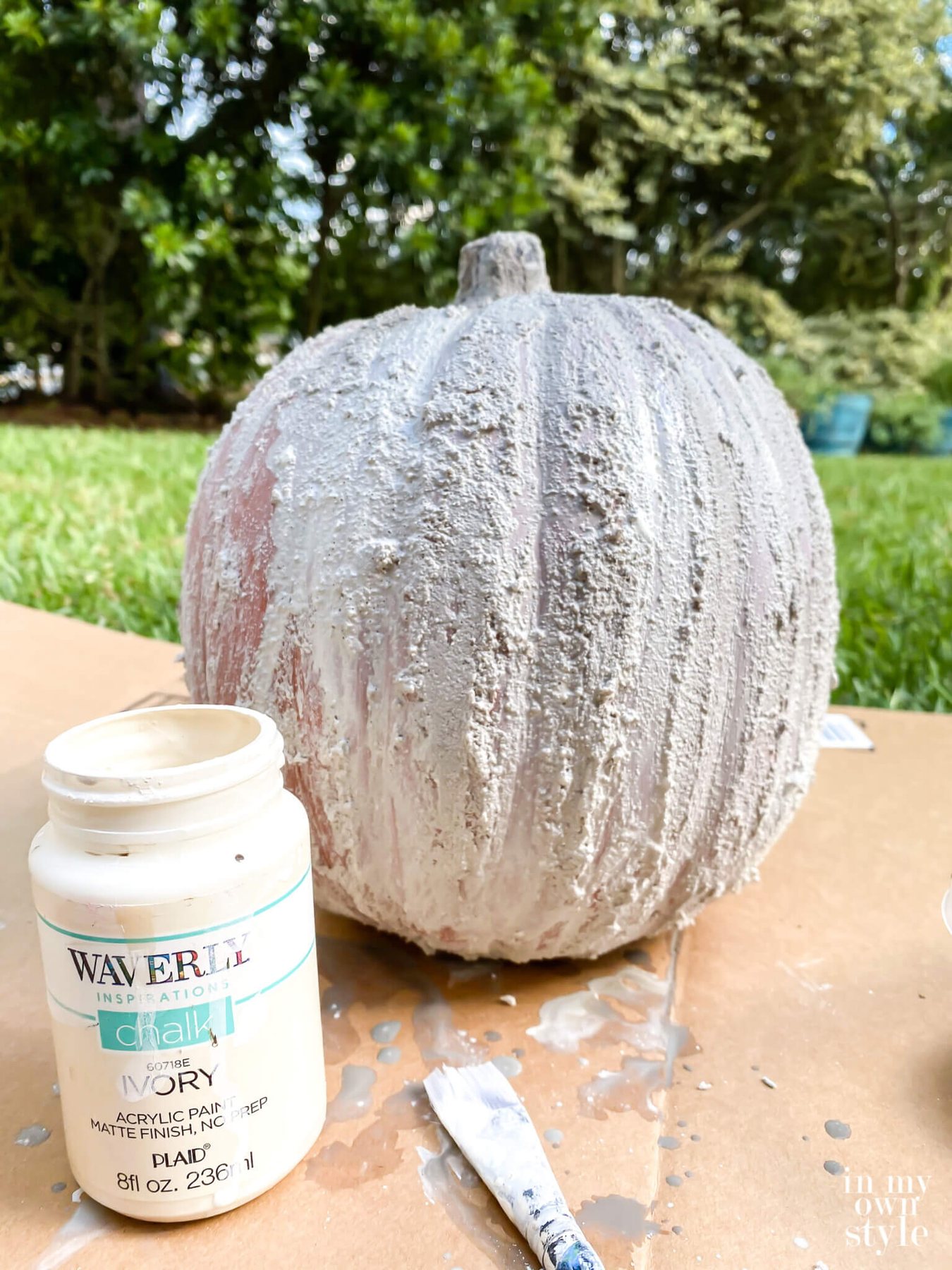 Paint added to fake pumpkin that is being made to look like plaster.