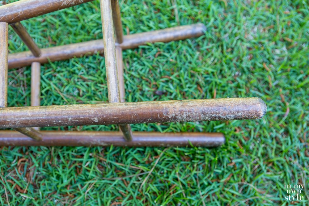 Close up of damage on a wood stool that gets a from trash to treasure furniture makeover.