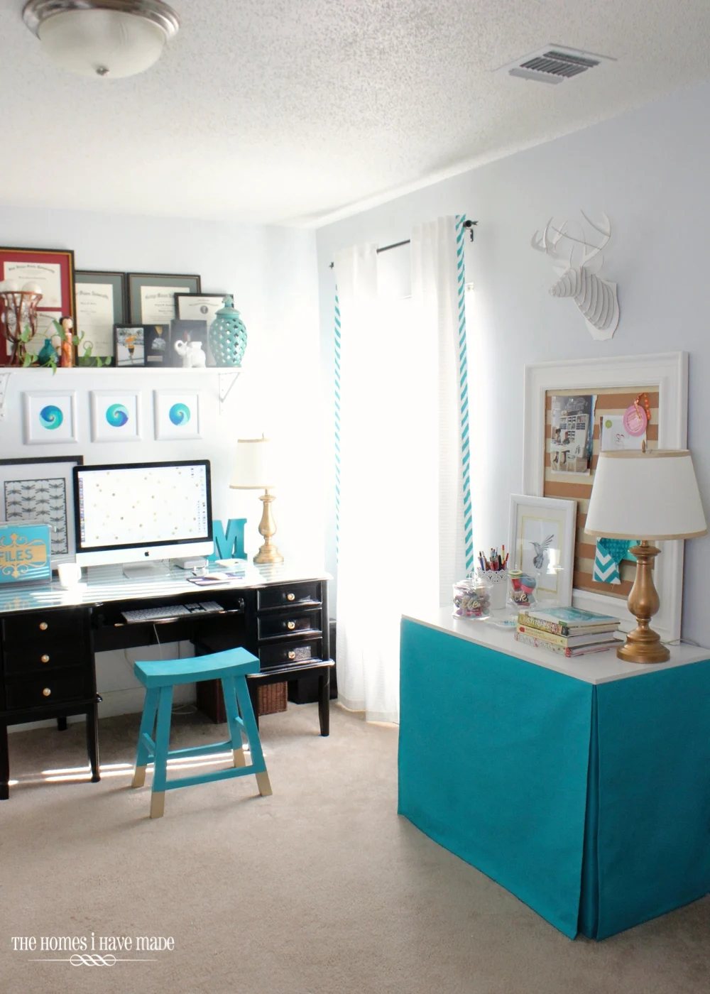 A turquoise fabric covered rectangular table in home office.
